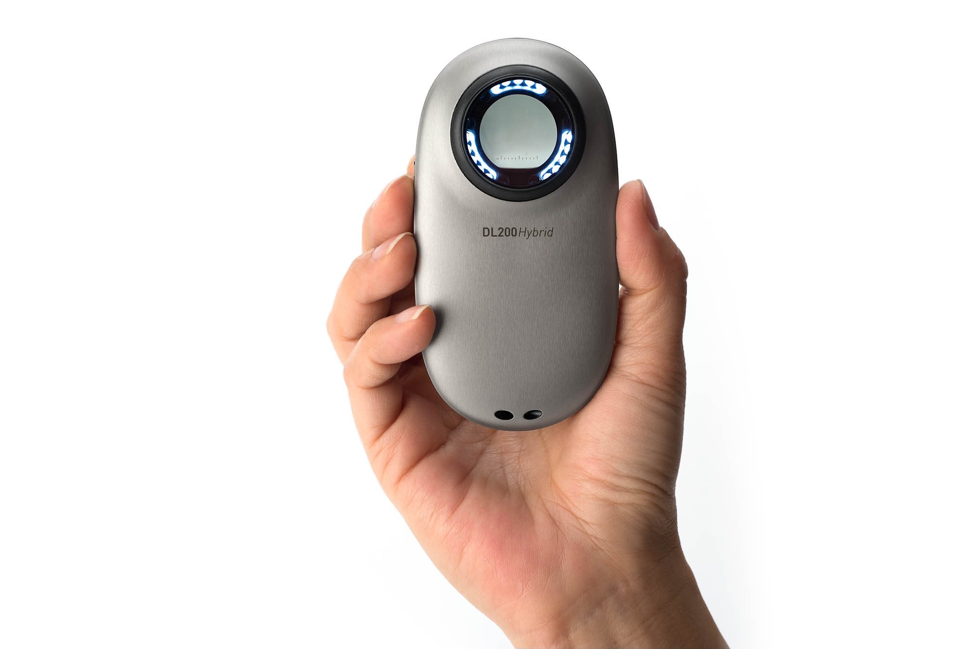Hand holding DermLite DL200 Hybrid dermatoscope.