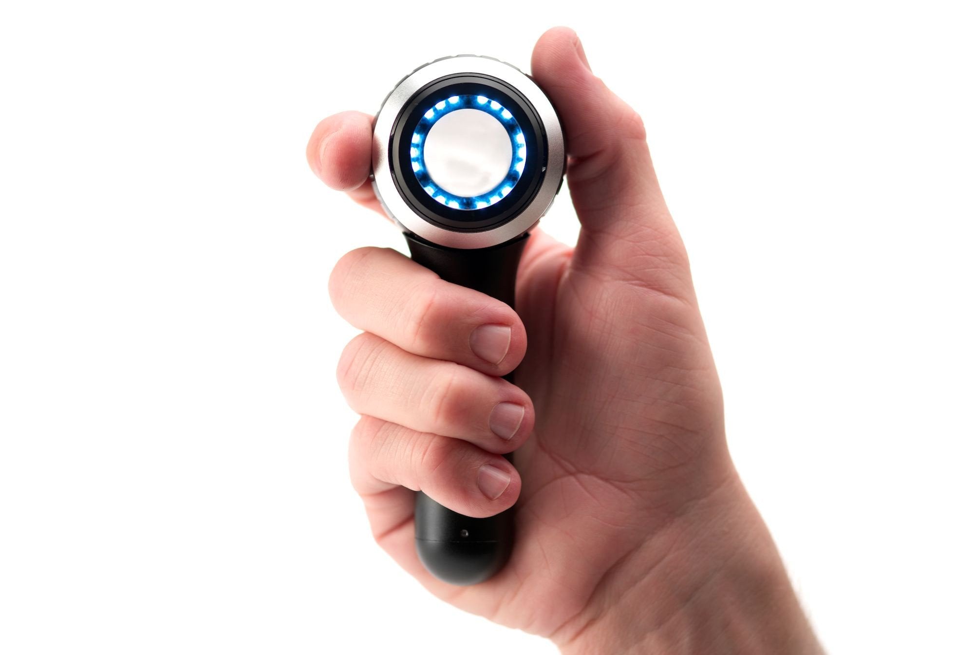 Hand holding DermLite DL4 dermatoscope with LEDs on.