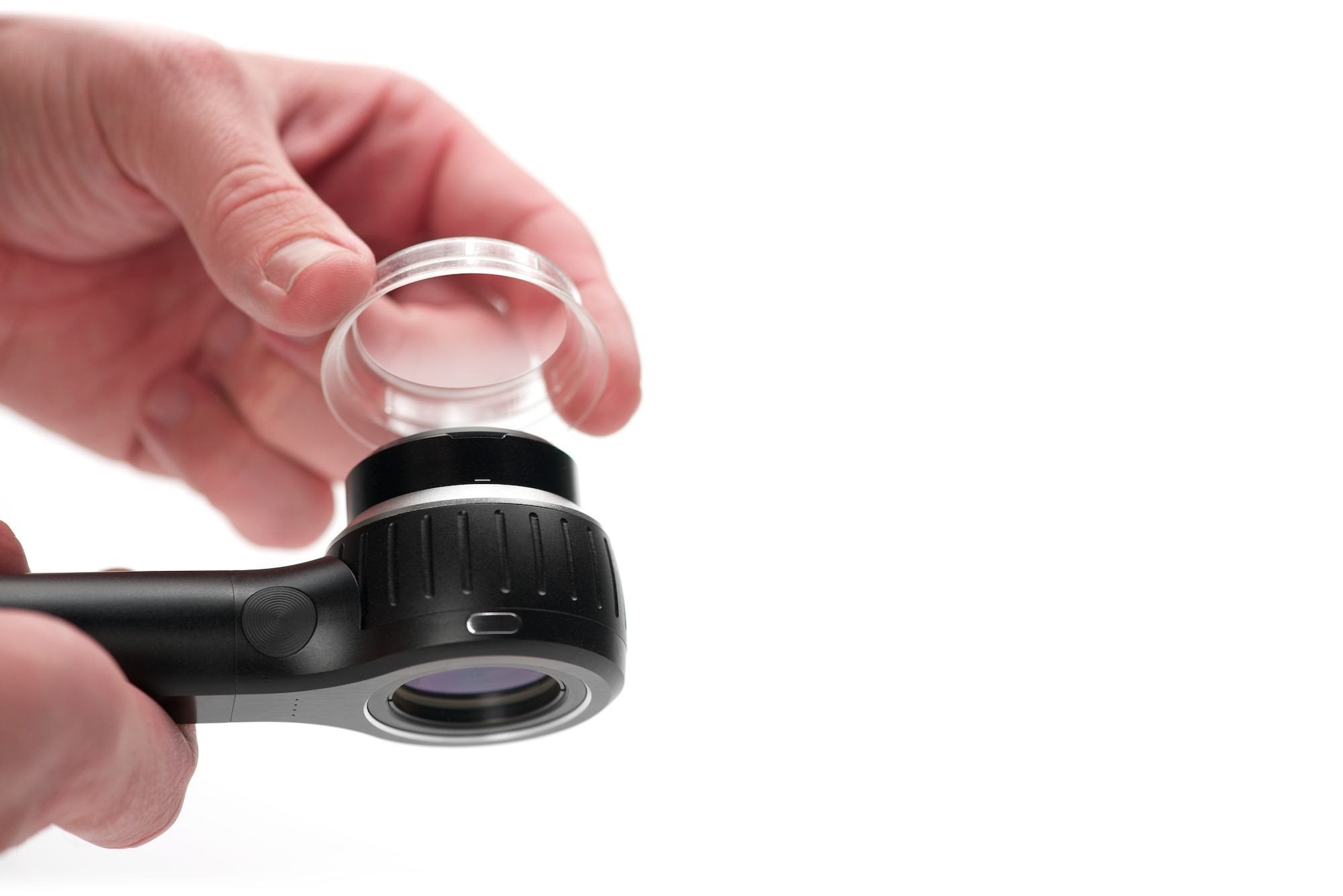 Hand holding DermLite DL4 and IceCap