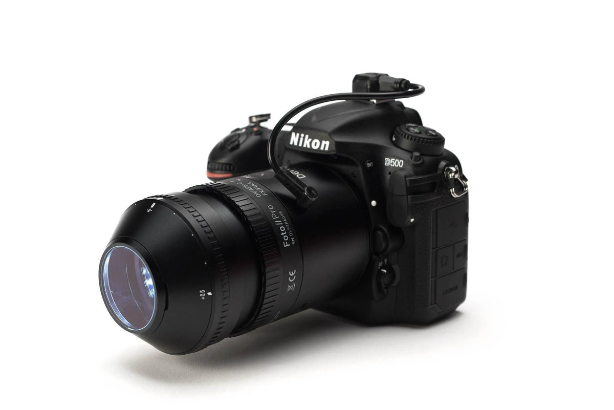 A Nikon D500 DSLR camera body with a zoom lens, shown from a three-quarters angle on a clean white background.